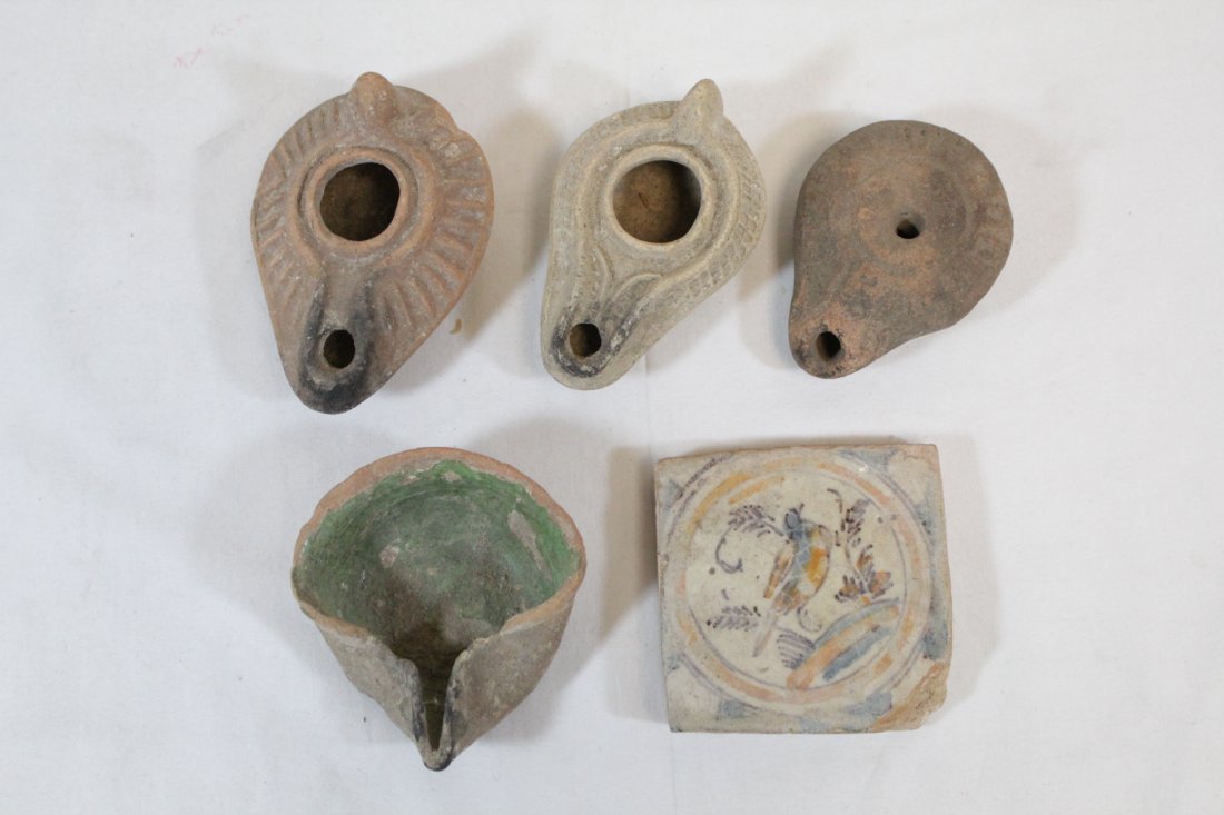 4 antique terracotta oil lamps, and an antique tile: 4 antique terracotta oil lamps (1.6"Hx3.45"x2.25", 1.75"Hx3.6"x2.6", 1.15"Hx3.1"x2.25", 1.2"Hx3.25"x2.95") , and an antique tile (3"x3"x0.65") from Barcelona Spain (chip)
