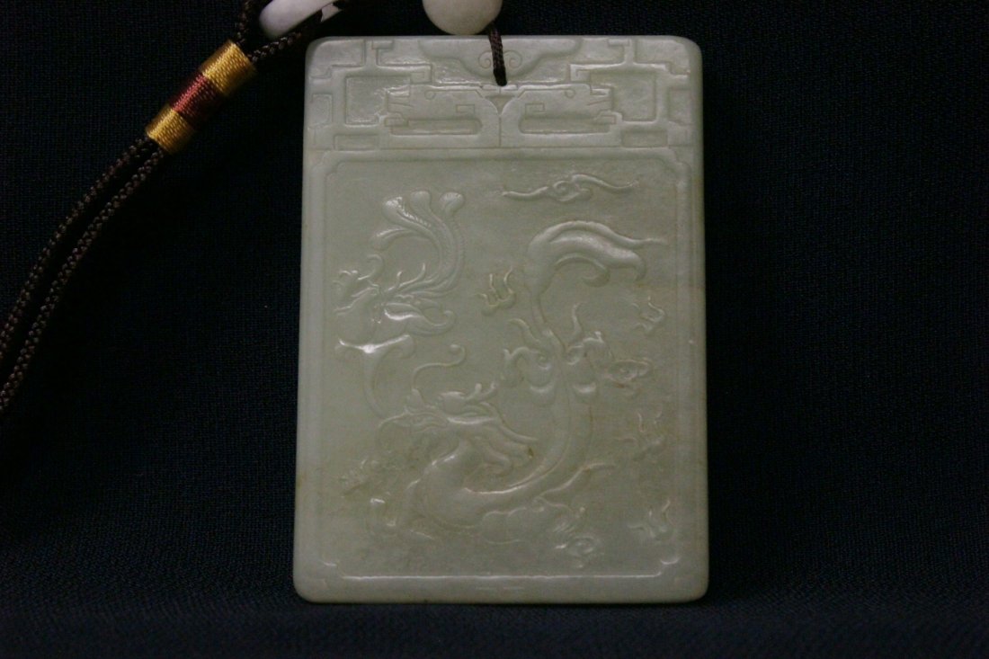 A large Chinese celadon jade carved pendant (1 of 9)
