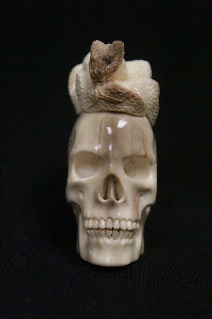 Ivory carved skull with snake on top (1 of 10)