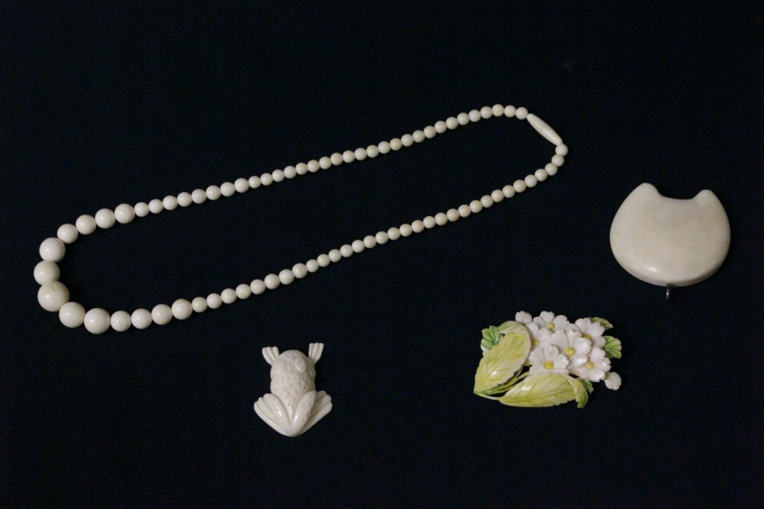 4pc of ivory: 4pc of ivory; a pendant (1.65"x1.75"x0.5"), a floral brooch (2.2"x1.6"), a frog (1.45"L), and a necklace (18.2"L) , NO INTERNATIONAL SHIPPING OF IVORY