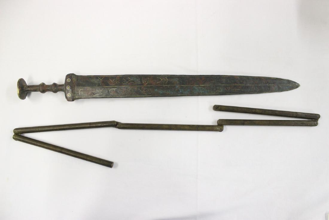 A bronze weapon and a 20th c. bronze sword: A bronze martial art weapon (40"L) and a 20th century bronze sword (21.4"L)
