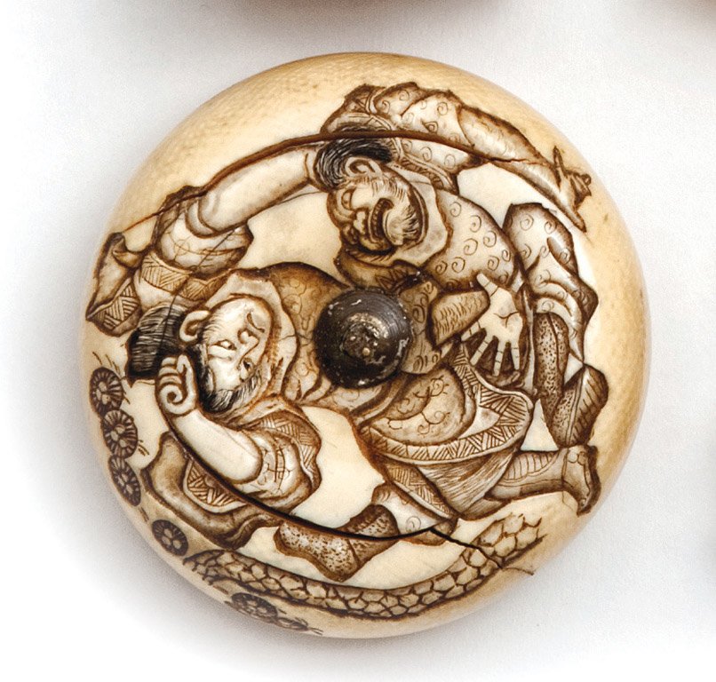 A Japanese ivory manju netsuke carved with a Samur: A Japanese ivory manju netsuke carved with a Samurai attacking a figure, Meiji period (1868-1912) Signed 6cm diameter