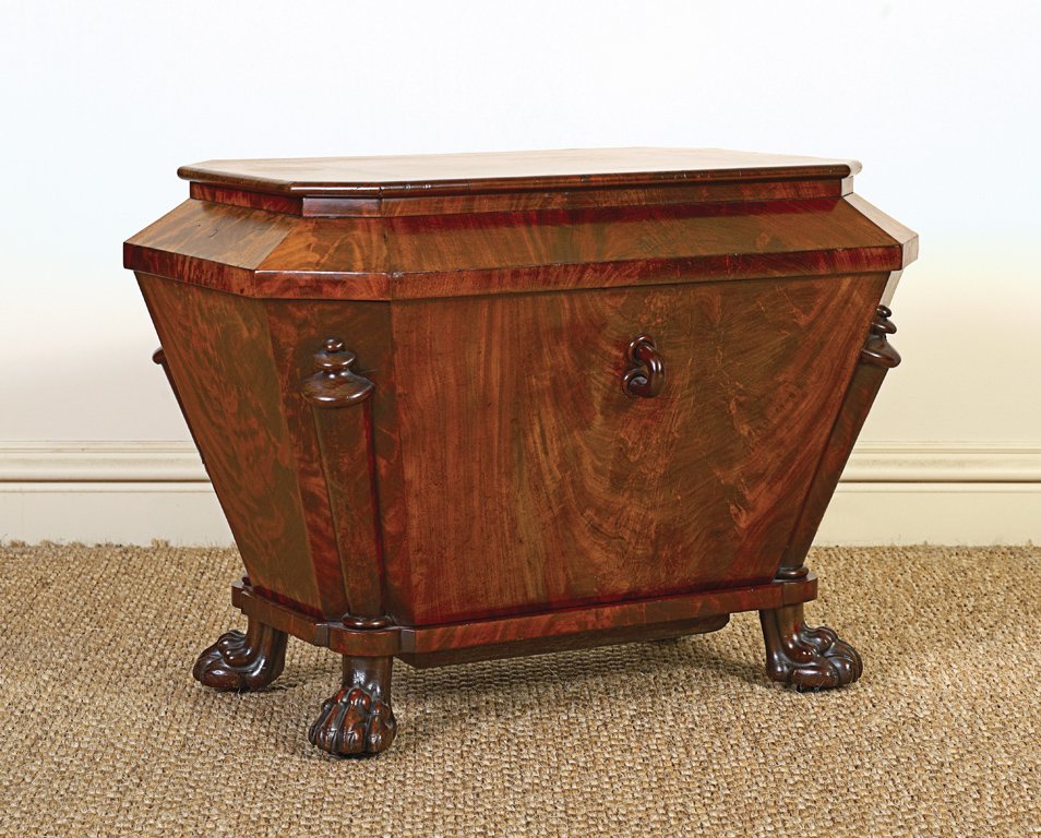 A George IV mahogany wine cooler in the form of a: A George IV mahogany wine cooler in the form of a sarcophagus with lion paw feet 60cm high, 85cm wide, 55cm deep