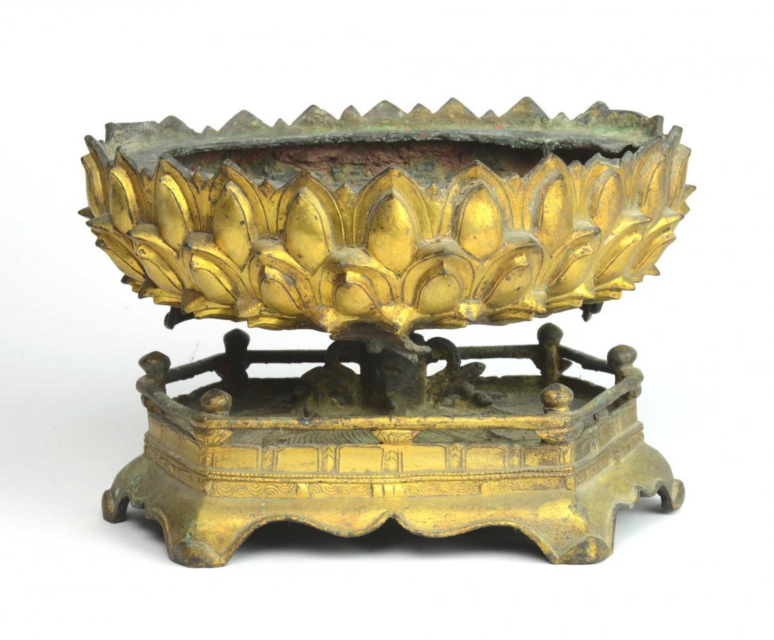 A good Chinese gilt-bronze lotus throne, Ming Dynasty, : A good Chinese gilt-bronze lotus throne, Ming Dynasty, 16th/17th century in the form of an open flower resting on a hexagonal base (made for a Buddhist figure) 16cm high, 23.5cm wide, 16.5cm deep