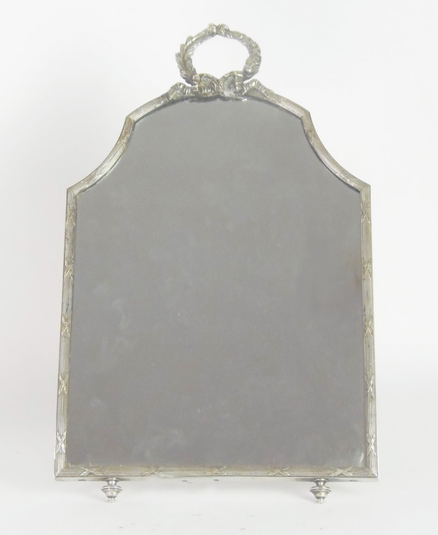 A silver-plated arched rectangular dressing table mirro