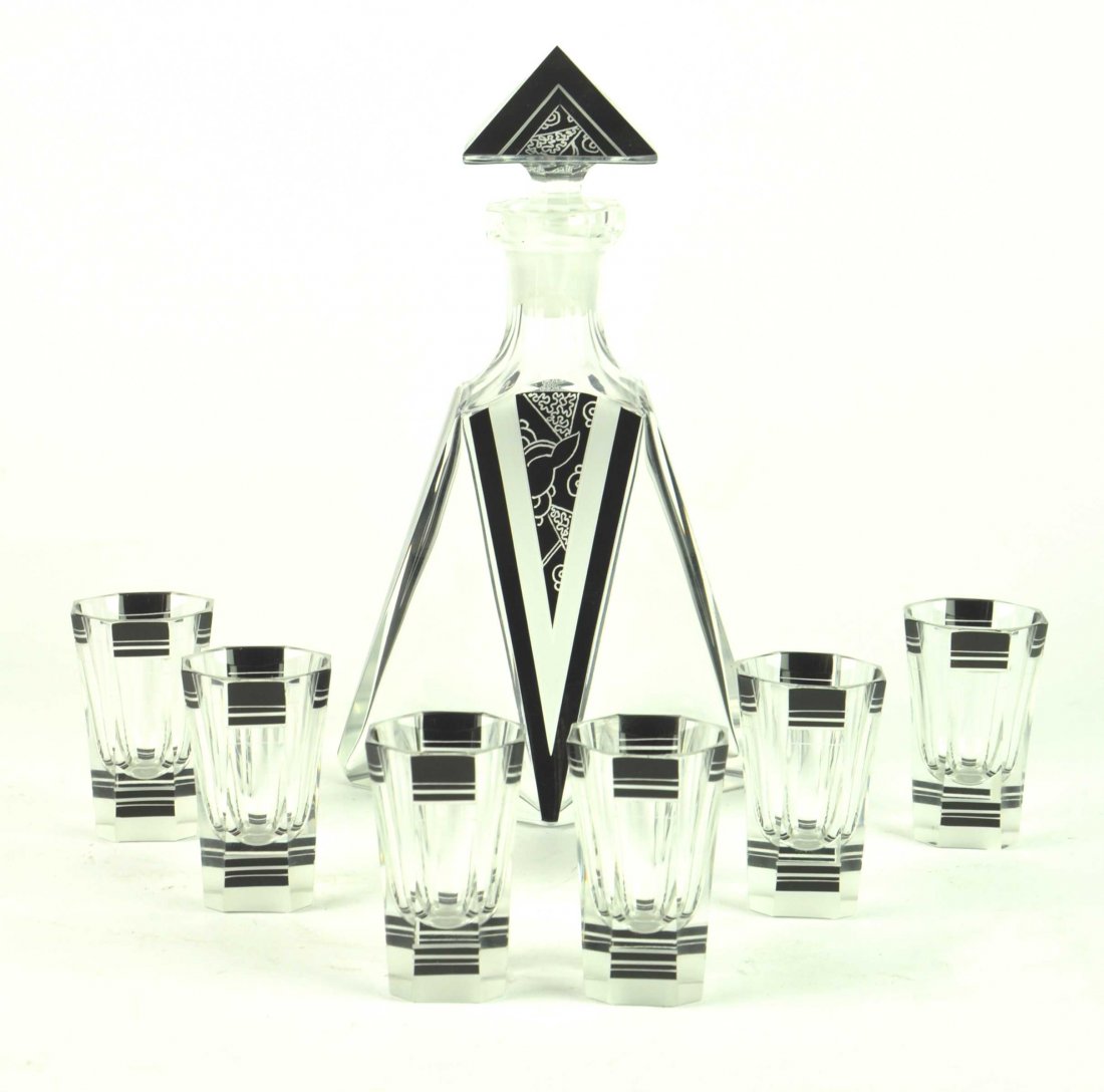 A seven piece Art Deco black enamel and cut glass lique