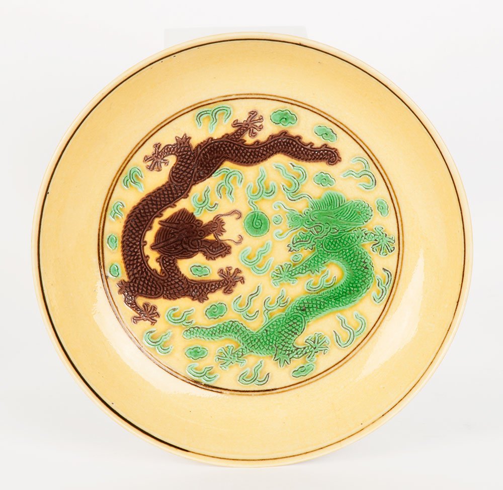 A Chinese Imperial green and aubergine dish, Tongzhi ma: A Chinese Imperial green and aubergine dish, Guangxu mark and period 1875-1908 decorated with confronting dragons, six character brown mark 13.1cm diameter Provenance A&G McPherson, London