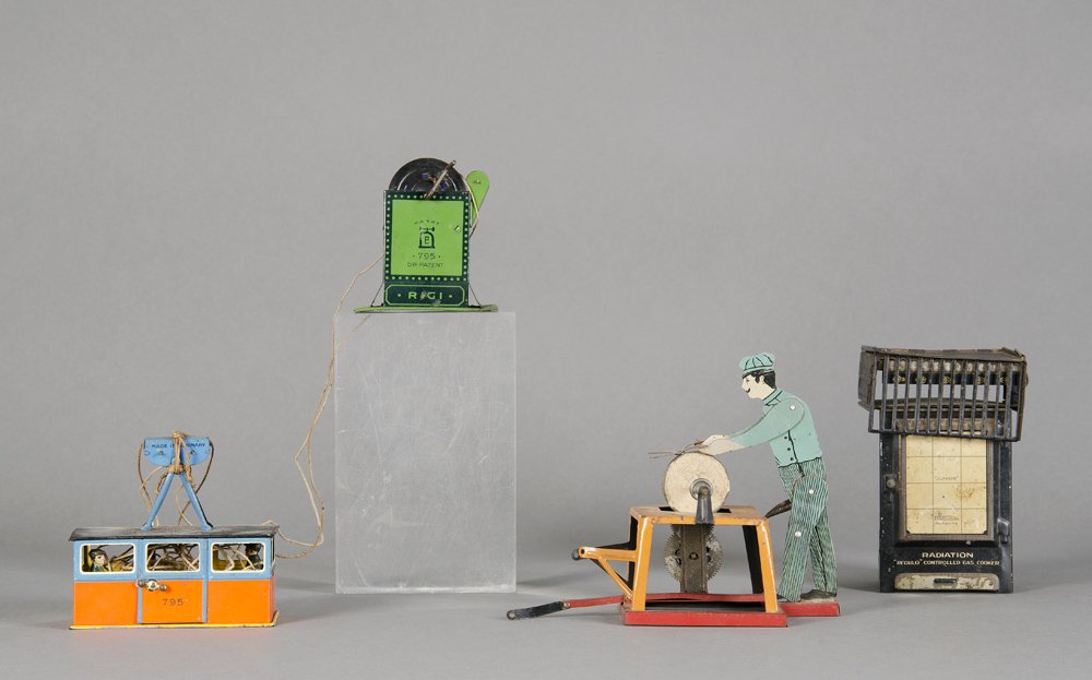 TIN TOYS: German Rigi cable car; English made: TIN TOYS: German Rigi cable car; English made “Radiation, Regulo Controlled Gas Cooker” money box; German clockwork toy scissor sharpening man (early 20th century). (3 items)