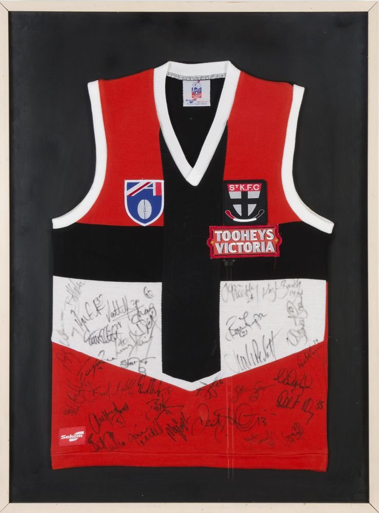 ST.KILDA: c1997 St.Kilda football jumper with 30: ST.KILDA: c1997 St.Kilda football jumper with 30 signatures, noted Robert Harvey, Nathan Burke & Stewart Loewe, framed & glazed, overall 71x94cm.