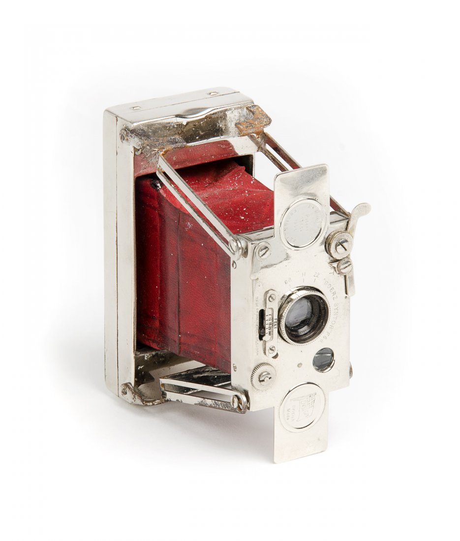 HOUGHTONS (England): Ensignette No.2 bedless strut: HOUGHTONS (England): Ensignette No.2 bedless strut camera, c1911, with nickel-plated body and red bellows.