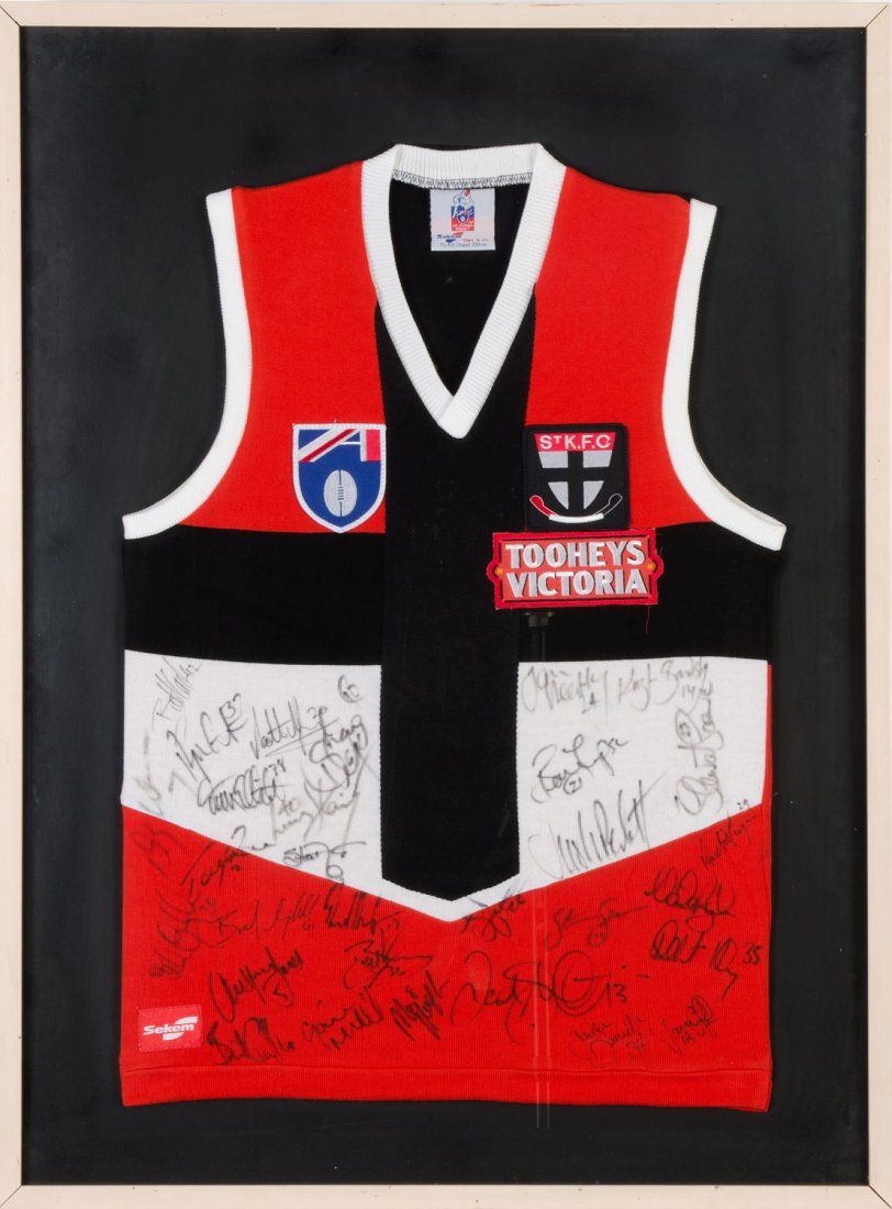 ST.KILDA: c1997 St.Kilda football jumper with 30: ST.KILDA: c1997 St.Kilda football jumper with 30 signatures, noted Robert Harvey, Nathan Burke & Stewart Loewe, framed & glazed, overall 71x94cm.