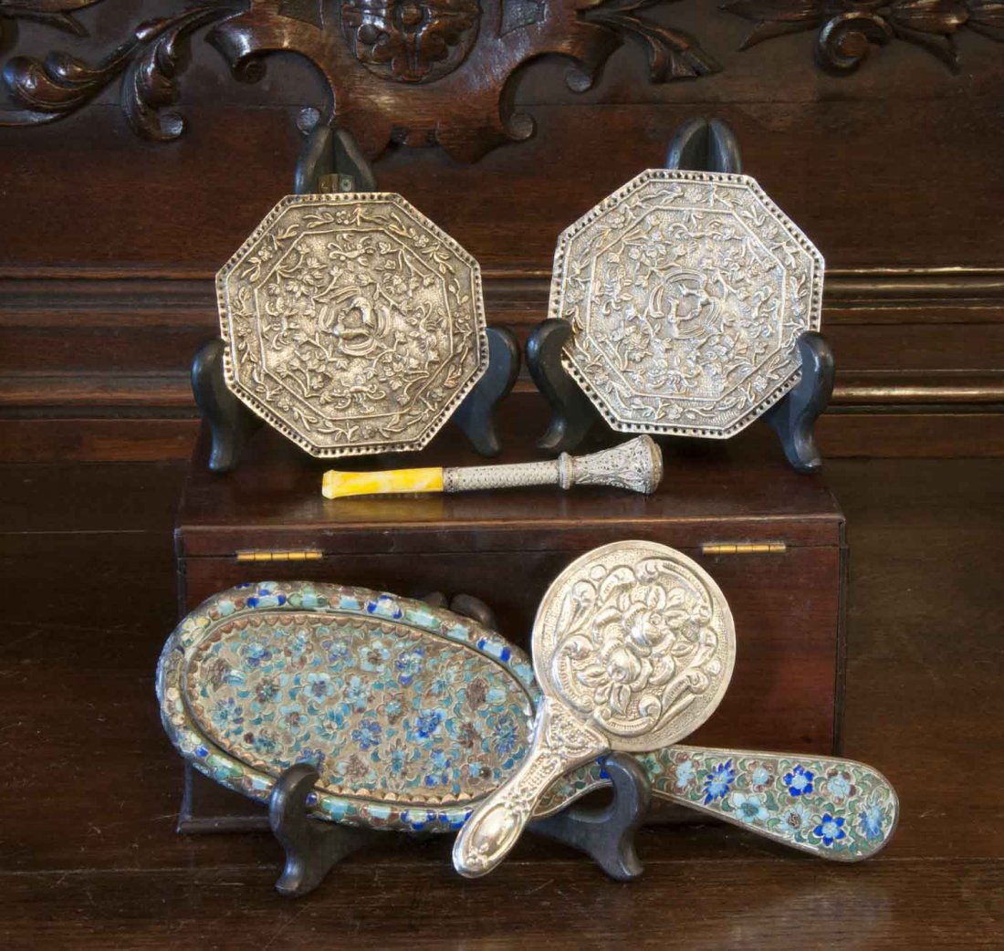 A Chinese cloisonné hand mirror, an Indian hand mirror,: A Chinese cloisonné hand mirror, an Indian hand mirror, two Indian silver plaques and a silver mounted cigarette holder $100–200