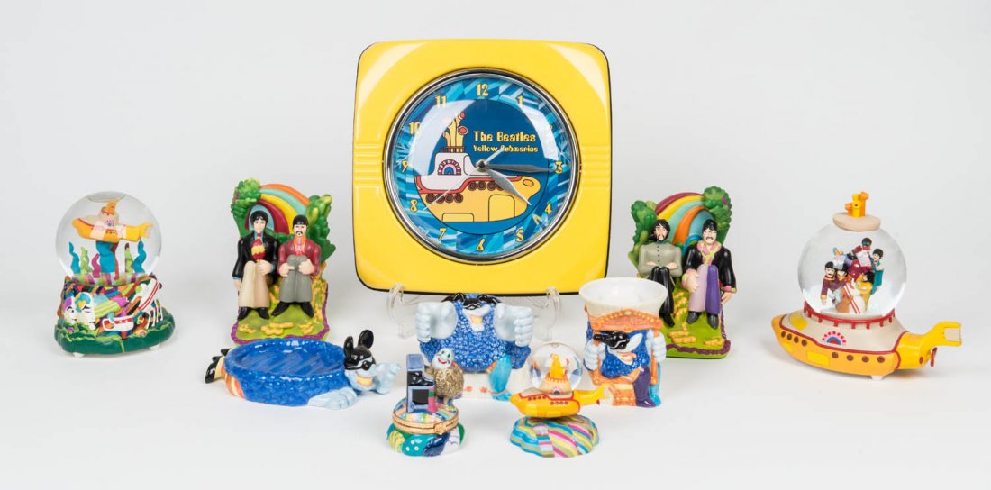 THE BEATLES: A collection of "Yellow Submarine": THE BEATLES: A collection of "Yellow Submarine" memorabilia in original packaging; including Musical Globes, bookends, a wall clock, etc,. (7 items).