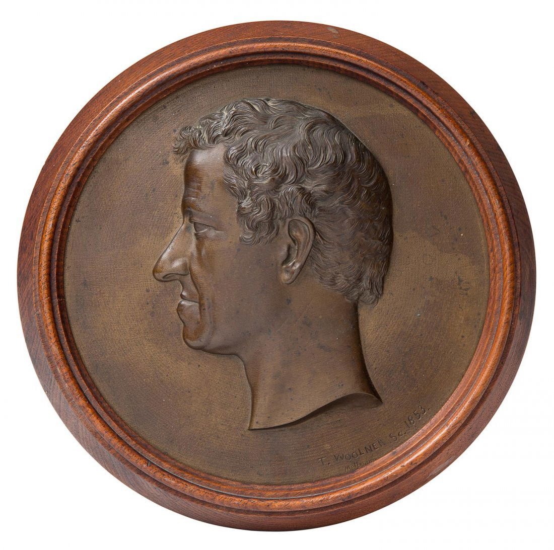 THOMAS WOOLNER bronze plaque of Governor Charles: THOMAS WOOLNER (1825 - 1892) bronze plaque of Governor Charles LaTrobe, signed "T.Woolner Sc,1853", housed in original timber frame. PROVENANCE: By direct family descent. Plaque 22cm.