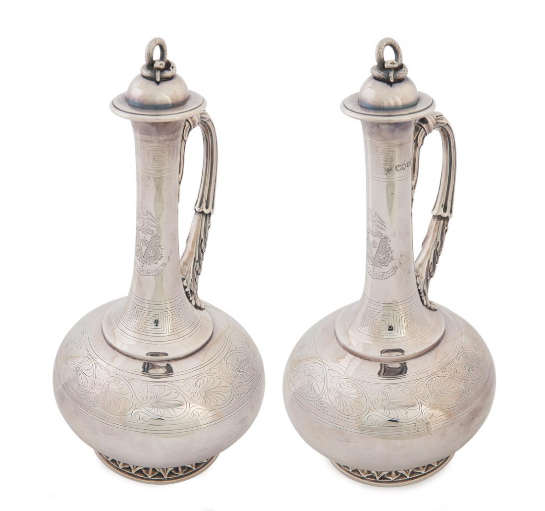 A fine pair of Victorian sterling silver classical form: A fine pair of Victorian sterling silver classical form wine jugs with coiled snake finials and contemporary coats of arms by Stephen Smith & William Nicholson, London 1858/9 30 cm high, 1,870 grams t