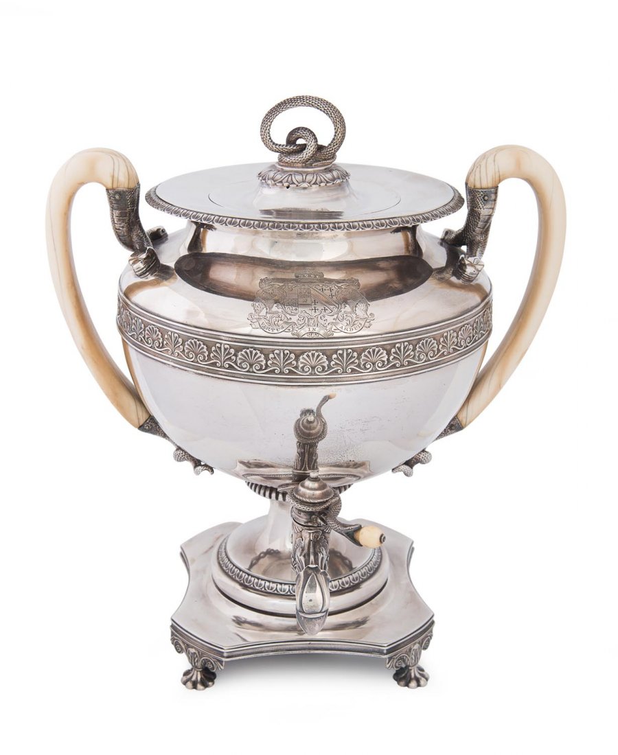 A George III sterling silver tea urn: A George III sterling silver tea urn with carved ivory loop handles and engraved contemporary coat of arms by Benjamin Smith II & James Smith III, London 1810, the original coiled snake finial by