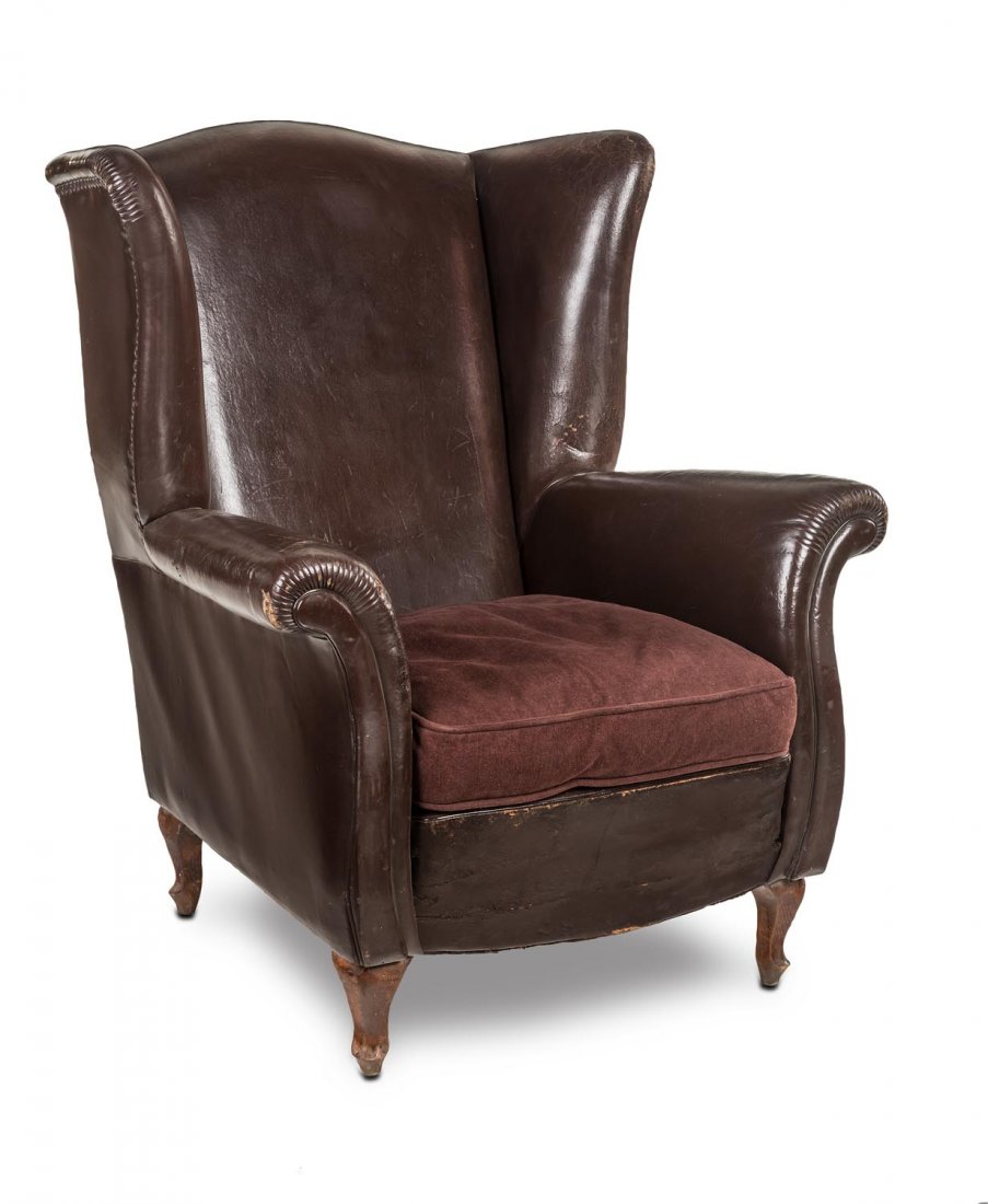 A chocolate leather wing armchair with velvet cushion, (1 of 1)