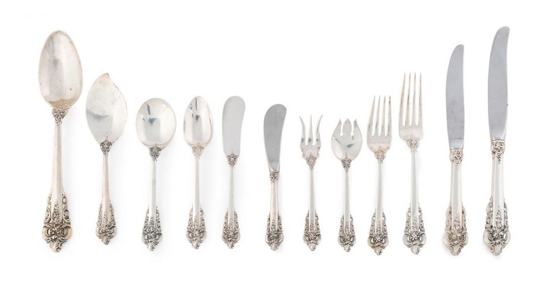 An American sterling silver cutlery suite by Wallace: An American sterling silver cutlery suite by Wallace Silversmiths Inc., in the Grande Baroque pattern, first introduced in 1941 comprising twelve dinner knives, sixteen dinner forks, ten entree knives