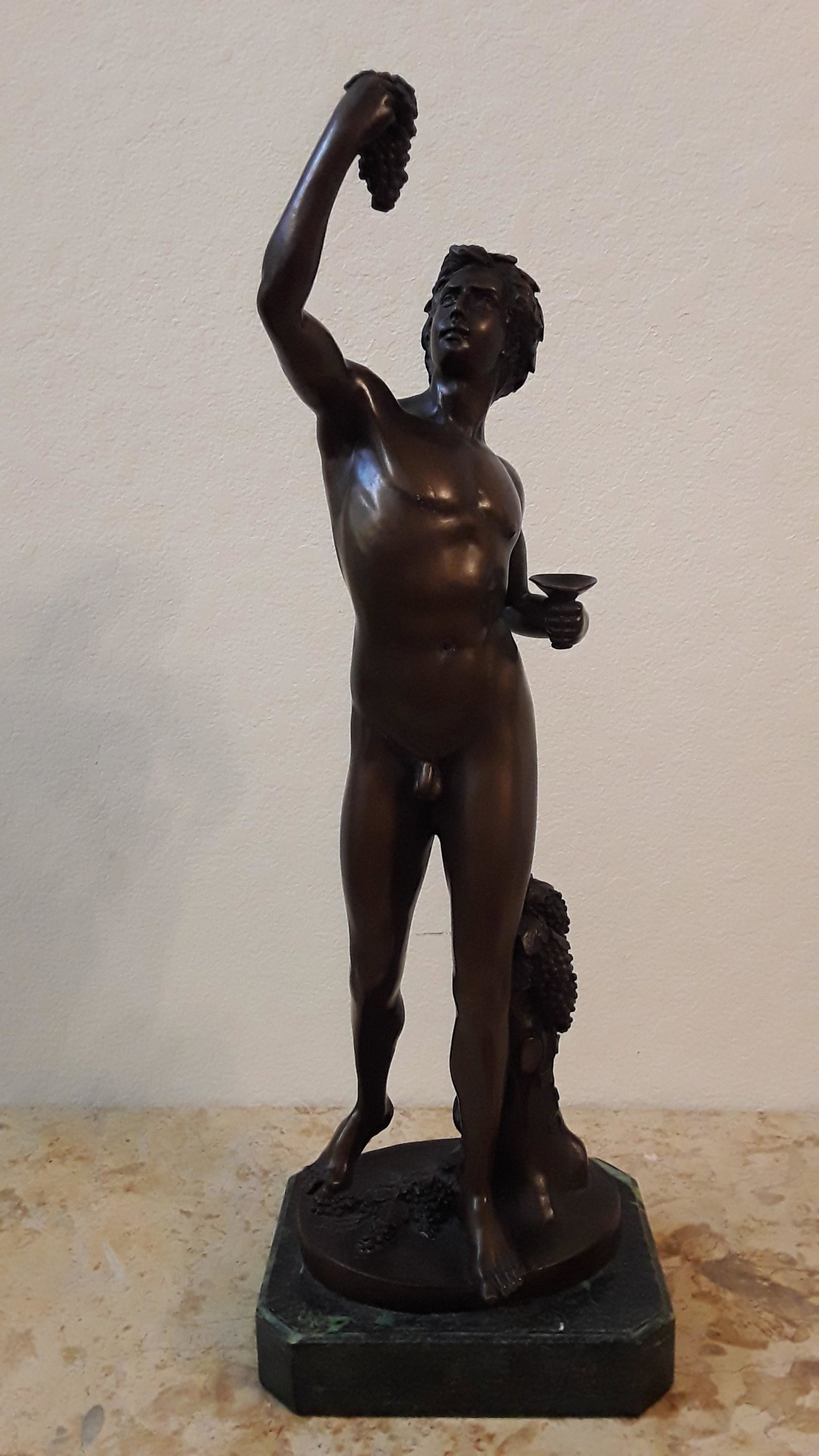 bronze statue of Bacchus (Dionysus): A bronze sculpture by the very well listed French Beaux Arts sculptor Louis Gossin (1846-1928), titled Bacco, depicting the Roman god of wine, holding a chalice and gazing playfully at a bunch of grap