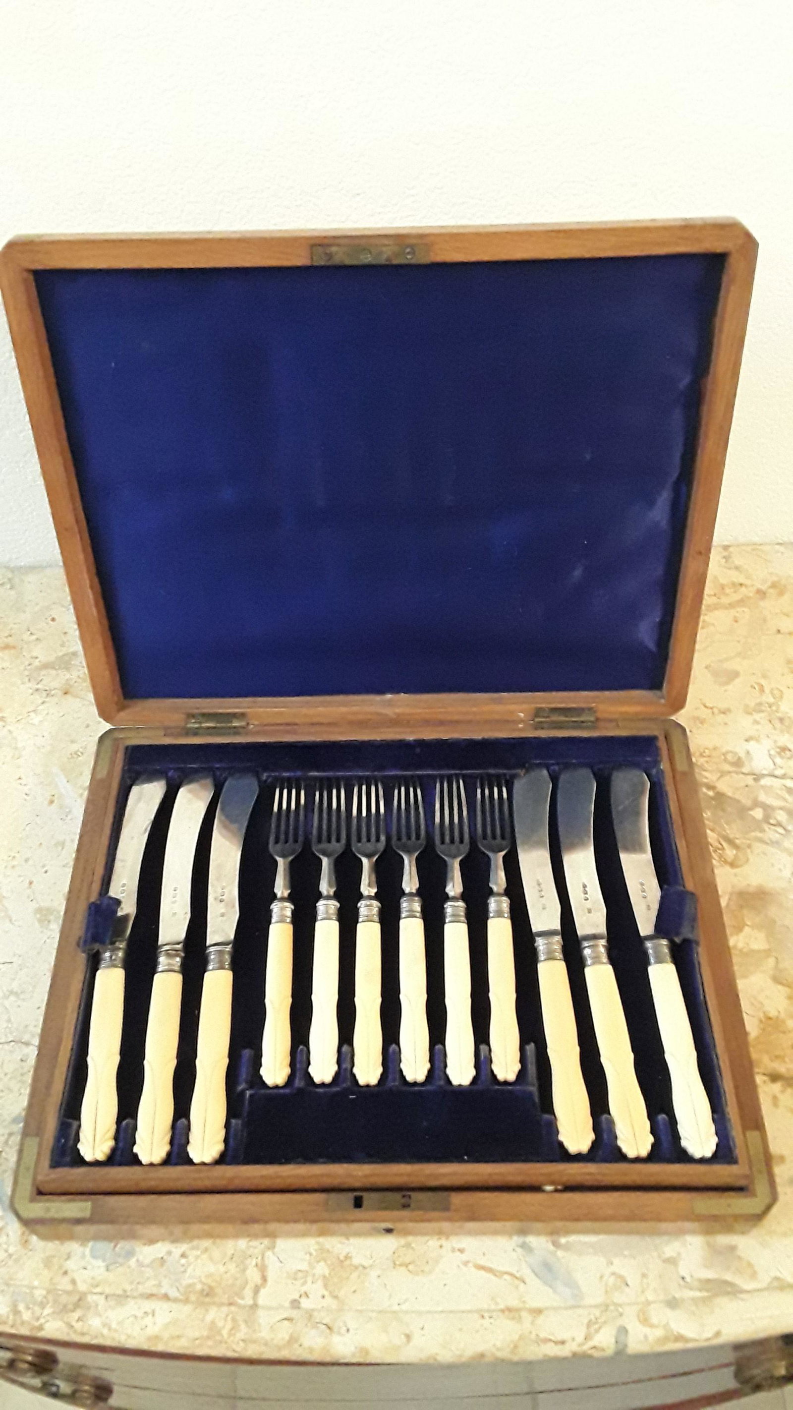 Bone Fish Cutlery Set with Case: An antique Sheffield fish flatware set , offers 12 forks and 12 knives with bone handles housed in velvet lined original walnut case with inset brass shield