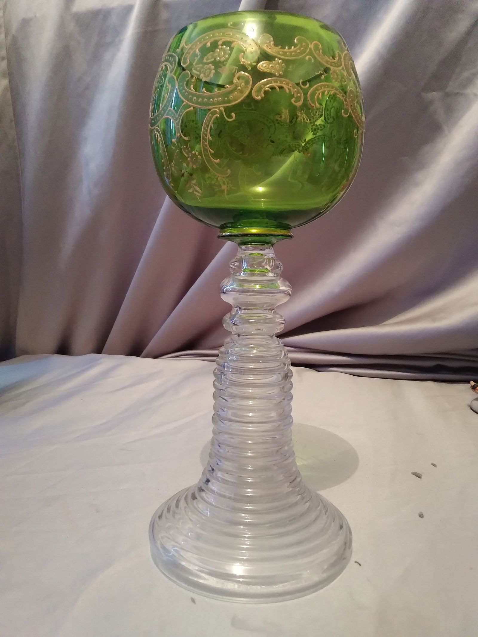 Bohemian glass goblet: wine glasses from the storied Czech Republic firm of Moser. Nicely applied decoration on the knob stem, a trumpet shape stepped, detailed raised gilt decoration on the bowl. A nice green color to the