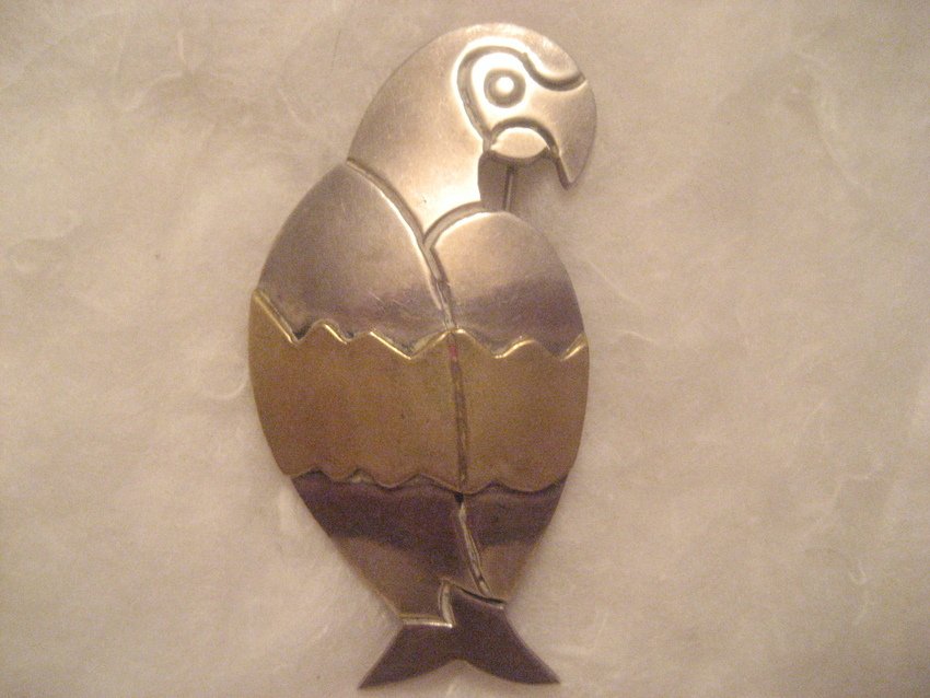 Large Sterling Silver Parrot Broach: Weight is 16.8 grams. Brass band across the center. Really cute. 2.25” long and 1 and 1/8” wide.