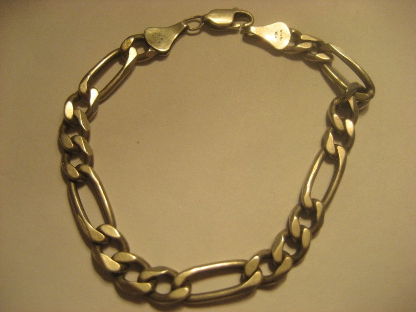 Sterling Figaro Chain Bracelet: Weighs 15 grams, 6” long and .25” wide.