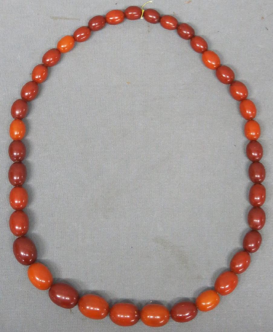 NECKLACE OF GRADUATED CHERRY AMBER BEADS (1 of 2)