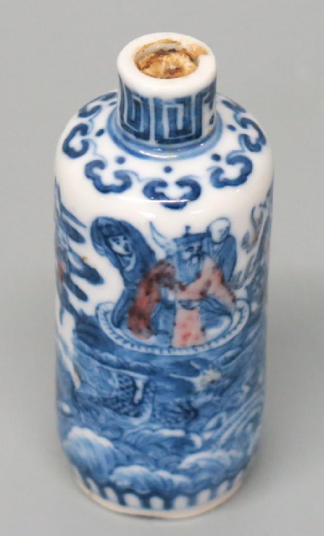 BLUE DECORATED CHINESE PORCELAIN SNUFF BOTTLE: BLUE DECORATED CHINESE PORCELAIN SNUFF BOTTLE 7.5cm. WITHE DEPICTIONS OF MYTHOLOGIACAL BEINGS; RED HIGHLIGHTS. SIGNED ON BOTTOM. STOPPER IS STUCK AND MISSING CAP.