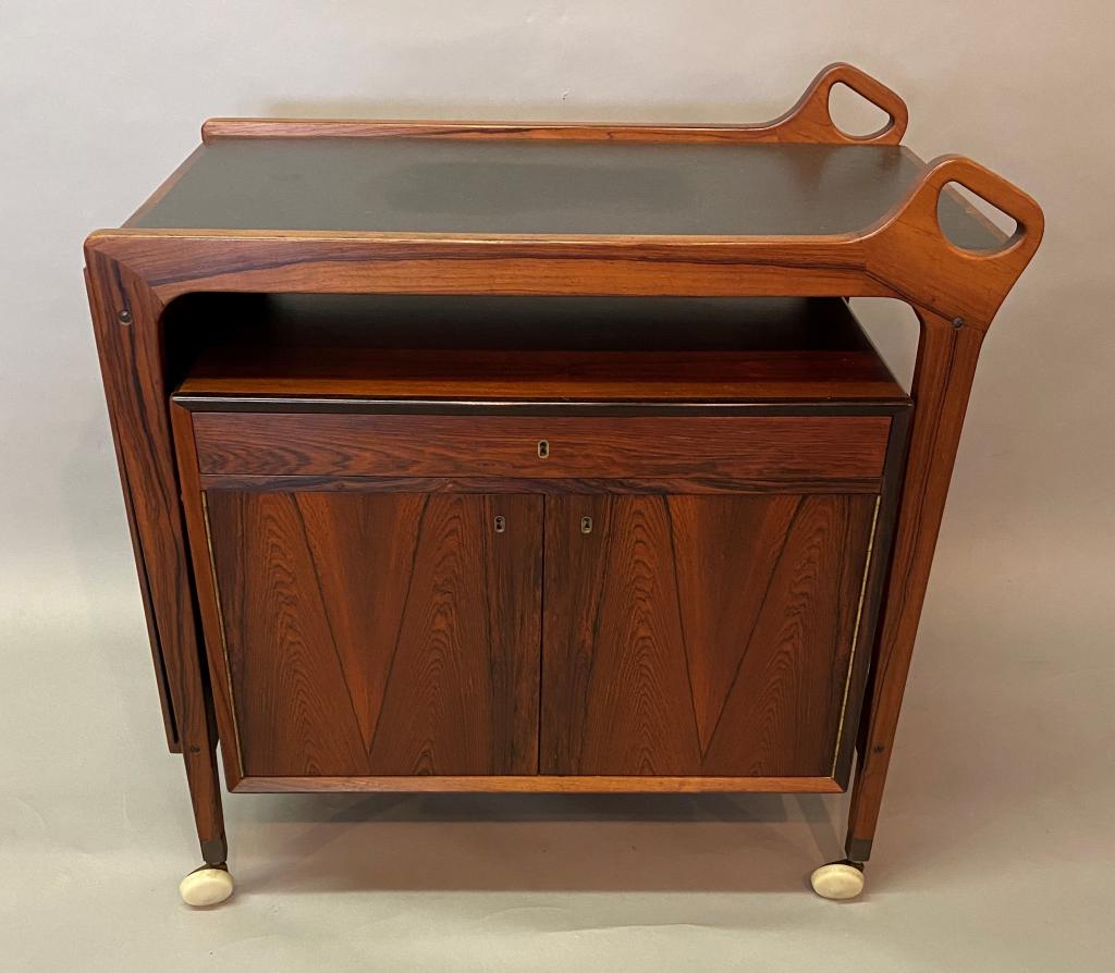 DANISH MODERN ROSEWOOD BAR CART BY DYRLUND: WITH BLACK LAMINATE TOP THAT IS EXPANDABLE; ALL ORIGINAL, EXCELLENT CONDITION (JUST A FEW MINOR SCUFFS ON TOP LAMINATE); APPROXIMATELY 34" X 22" AND 35" HIGH