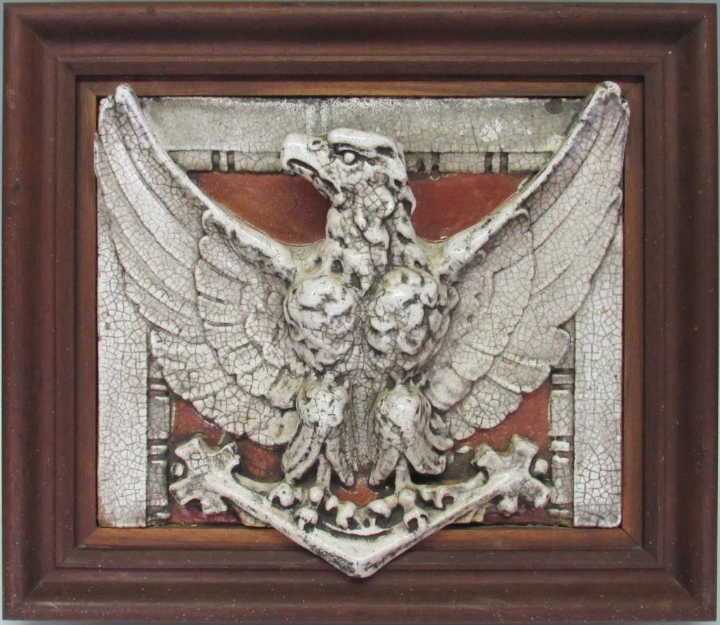 LARGE GLAZED EARTHENWARE ARCHITECTURAL EAGLE: MEASURES 18" X 15"; SET IN A 24" X 21" WOOD FRAME THAT WAS CRAFTED FOR IT; 78 POUNDS, ALL OVER GLAZE CRAZING AND ONE CHIP ON FRONT AT VERY TOP EDGE RIGHT SIDE