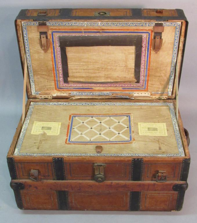 LEATHER COVERED STEAMER TRUNK BY NATHAN NEAT: WITH NICE ORIGINAL LABEL AND REMOVABLE TRAY; LEFT HANDLE DAMAGED AND SOME LEATHER LOSS ON BACKSIDE; 29" X 17" X 19"H