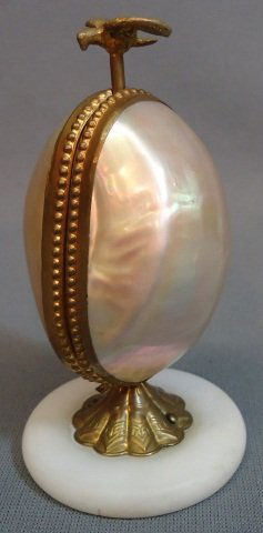 MOTHER OF PEARL EGG PERFUME CADDY: MOTHER OF PEARL EGG PERFUME CADDY WITH ORMALU AND MARBLE STAND; BIRD SHAPE CLASP OPENS THE EGG TO REVEAL TWO PERFUME VIALS; 5" TALL