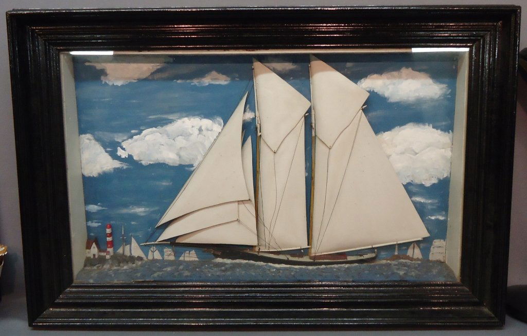HANDCRAFTED DIORAMA OF A 2-MASTED SCHOONER: DEPICTED IN FULL SAIL NEAR A LIGHTHOUSE; EARLY 20TH C; 20 1/2" X 34 1/2"; FRAME MEASURES 27" X 41"