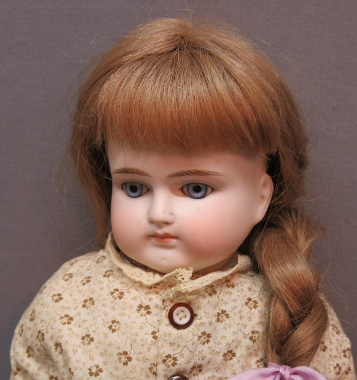 GERMAN BISQUE TURNED SHOULDER HEAD DOLL: POSSIBLY BY ALT, BECK & GOTTSCALCK; 24 1/2" TALL; CLOSED MOUTH, SET BLUE EYES, KID BODY, BISQUE LOWER ARMS; HAIRLINE UNDER LEFT EAR AND HAIRLINE ON LEFT SHOULDER