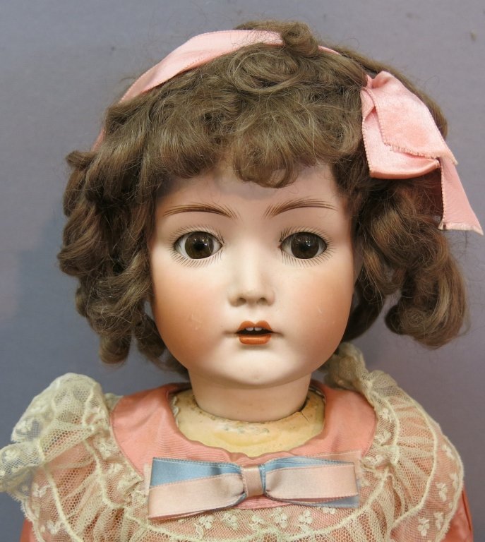 CUNO & OTTO DRESSEL BISQUE SOCKET HEAD DOLL: WITH SLEEP BROWN EYES, LASHES AS FOUND, OPEN MOUTH WITH TEETH; MINOR SCUFFS ON CHEEKS; BALL JOINTED COMPOSITION BODY, COMPOSITION AT NECKLINE COMPROMISED; 24" TALL