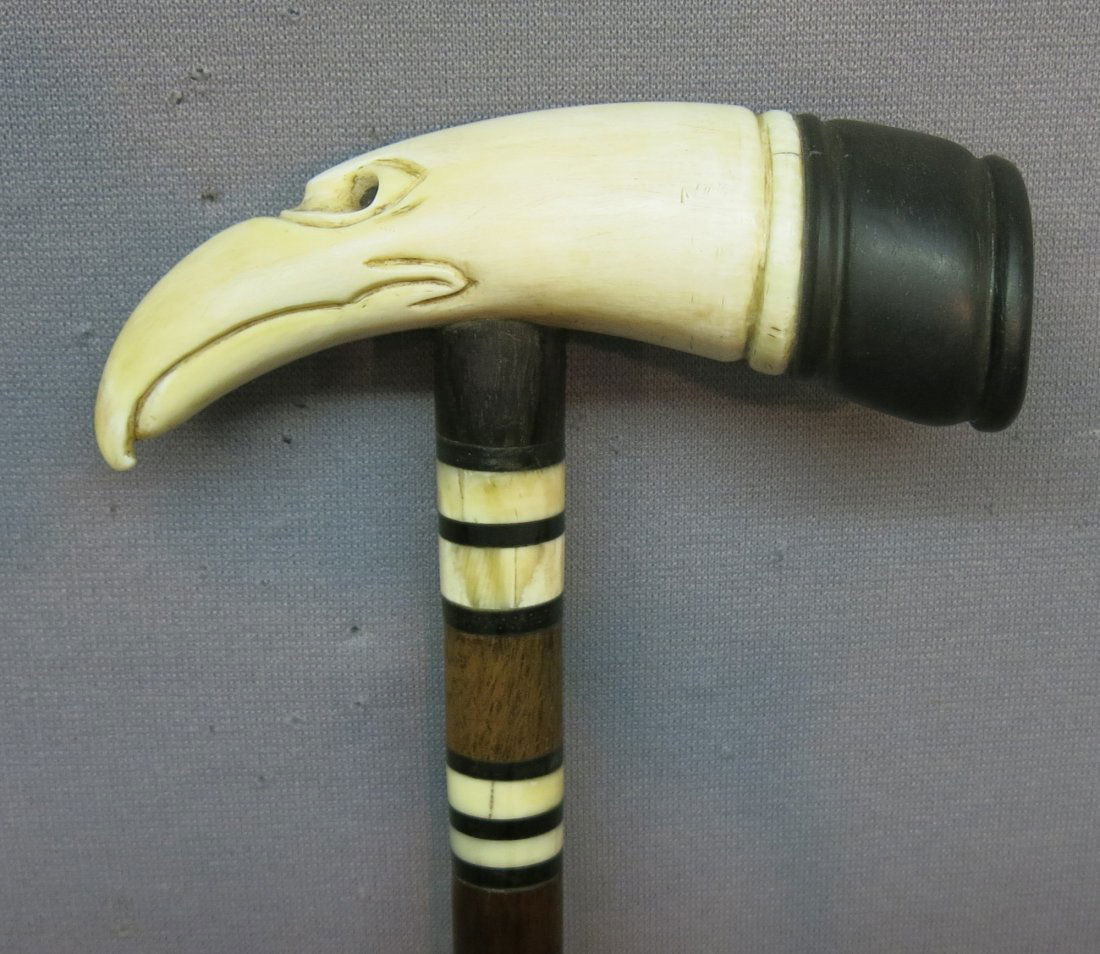 HANDCRAFTED ROSEWOOD CANE: WITH WHALES TOOTH CARVED AS AN EAGLE; EBONY AND WHALE IVORY BANDS, ABALONE INLAY; 36 1/2" LONG