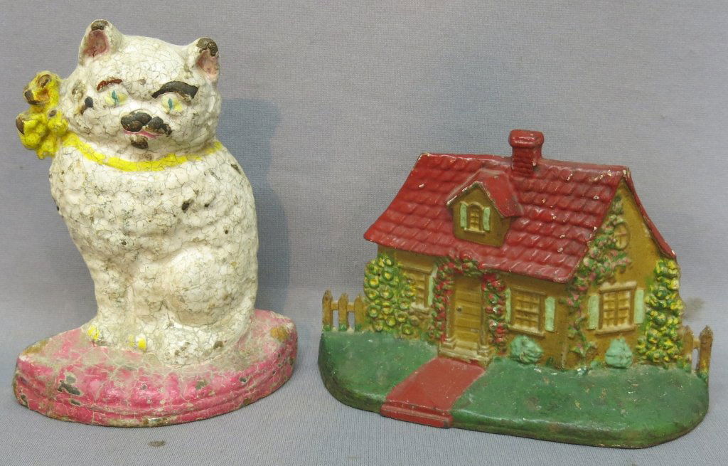 TWO CAST IRON DOORSTOPS - CAT AND COTTAGE: BOTH HAVE REPAINT; 7 1/2" AND 6" TALL