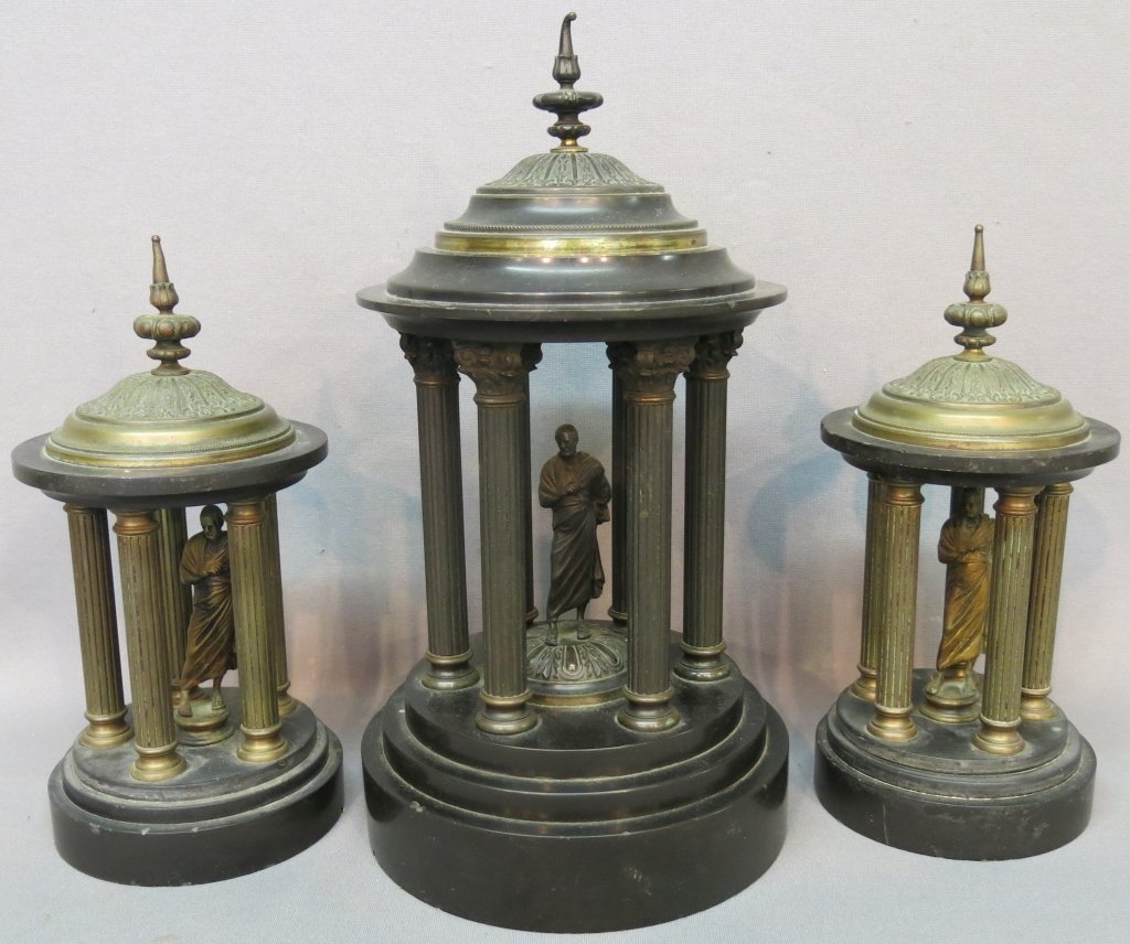 VICTORIAN BRONZE AND SLATE GARNITURE SET: CLASSICAL GREEK ROUND TEMPLE FORM, ENCLOSING BRONZE STATUETTES; 11" AND 14 1/2" TALL; THE TIP OF ONE FINIAL IS BENT