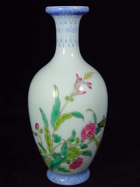 Chinese enameled vase from the early 1900s: A fine Chinese Famille Rose vase decorated with dahlia flowers and a cricket, signed Yongzheng, from the early 1900's. This vase is 8.5 inches tall, and 3.5 inches wide, in excellent condition.