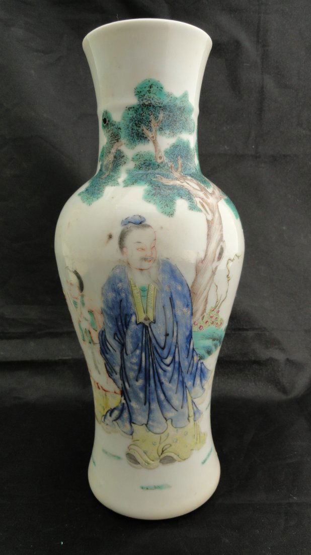 023: Chinese Famille Rose vase from the early 1900's: A Chinese vase decorated in famillle rose enamels to show a scholar taking a field trip with his servant, signed Qianlong but from the early 1900's. This vase measures 10 tall and 4 inches wide, in ex