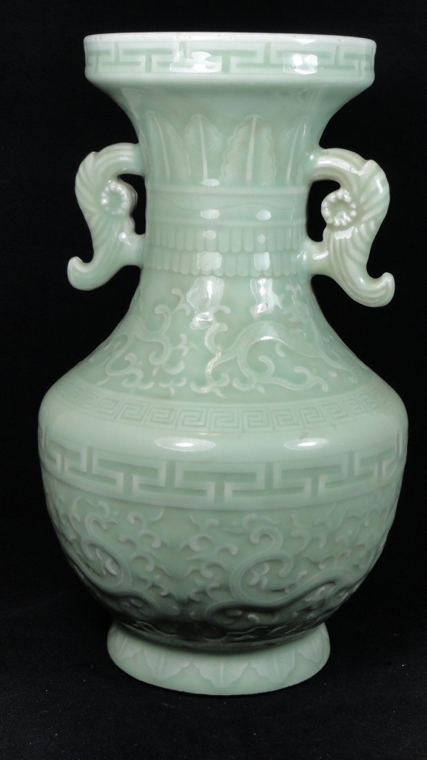 19th Century Chinese Export Celadon vase: A Chinese export vase decorated with raised dragons, and flanked by two handles. This vase is 13 inches tall and 8.5 inches wide, in excellent condition with minor rim frits.