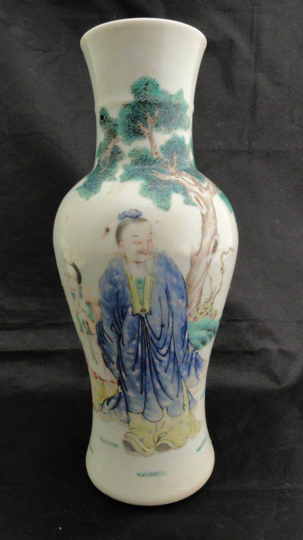 Chinese Famille Rose vase from the early 1900's: A Chinese vase decorated in famillle rose enamels to show a scholar taking a field trip with his servant, signed Qianlong but from the early 1900's. This vase measures 10 tall and 4 inches wide, in ex
