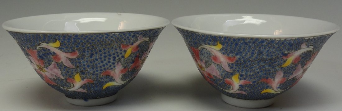 Two Chinese cups with Guangxu Mark: Pair Chinese Famille Rose cups decorated with floral patterns, signed GuangXu, from the early 1900's. These cups are 1.5 inches tall, and 3 inches wide, in excellent condition with minor gild loss. Th