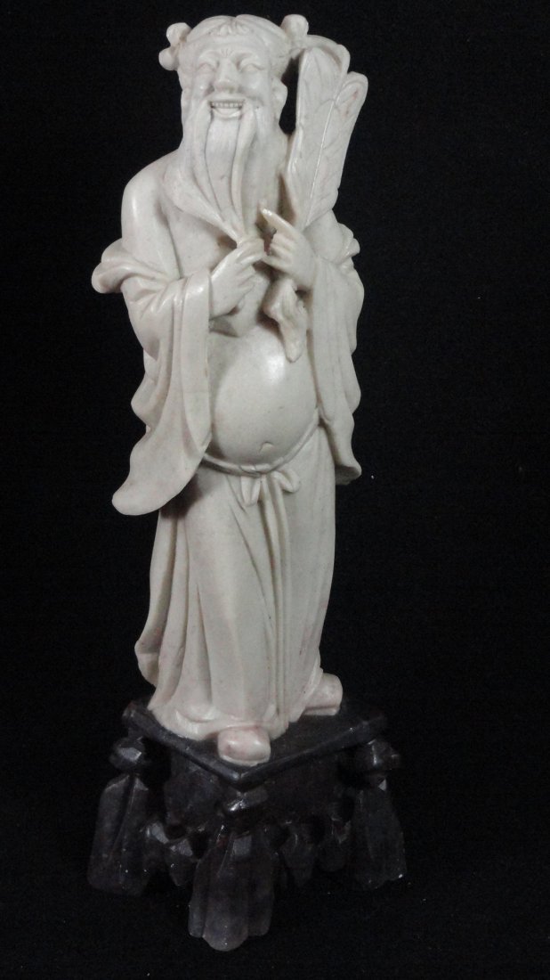 19th Century Chinese Soapstone Figure of a Deity: A fine Chinese Soapstone figure of a deity, with his left hand holding a large fan, and right hand on his long beard. There are a lot of details on the robe and fan. This figure is 8.5 inches tall, in