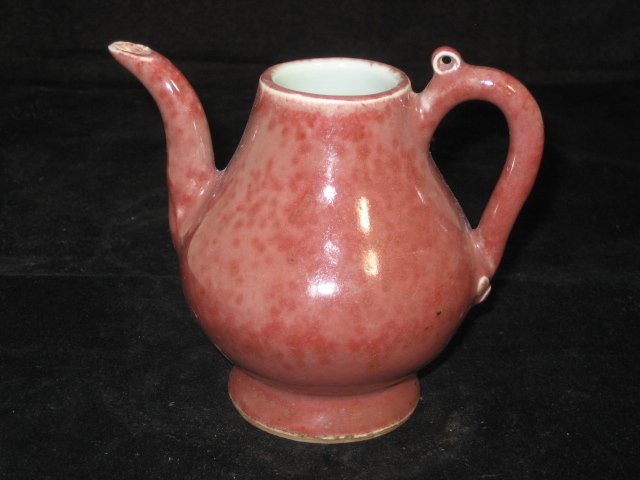 Rare 16th Century Chinese Copper Red Teapot: A Chinese teapot decorated in the rare copper red glaze, with unglaze bottom, from the Ming Dynasty. This teapot is 4.5 inches wide from the handle to the sprout, and 4 inches tall, in excellent condi