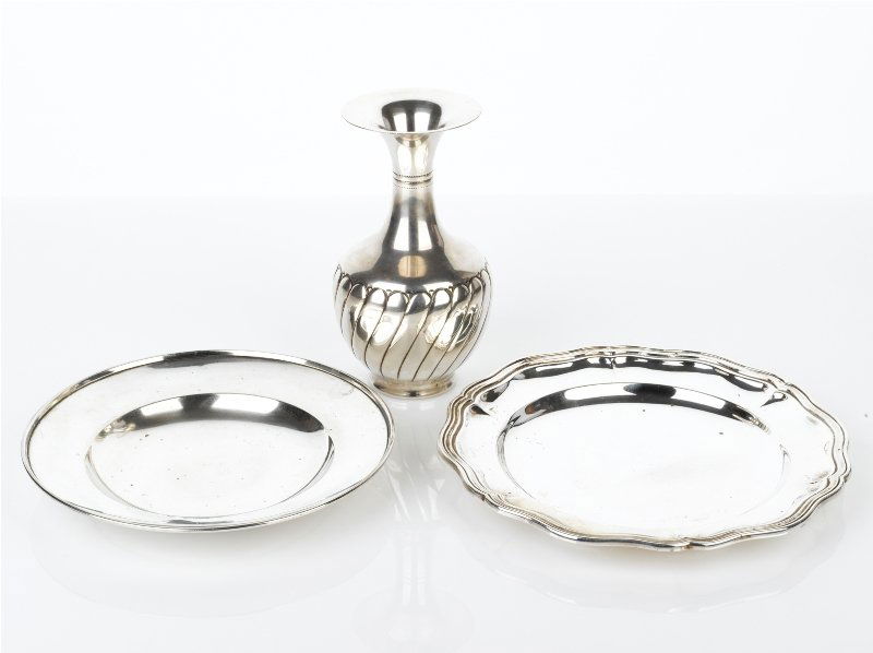 Collection of Silver Table Accessories: comprising a circular plate with reeded border, marked 800, probably Italian, another plate of plain form with ribbed rim, marked 900, together with a vase of ovoid form with swirl flute, a long neck