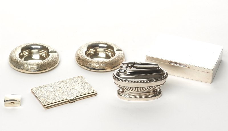 Collection of Silver Accessories: comprising a cigarette box together with a card case, a pill box, a pair of circular ashtrays and a Ronson lighter (6) cigarette box 12 x 9 x 3 cm