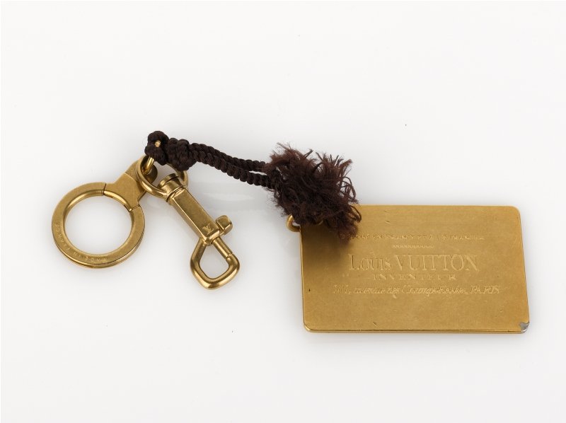 Louis Vuitton Brass Plaque Key Holder/ Bag Charm: Louis Vuitton Brass Plaque Key Holder/ Bag Charm of rectangular design, engraved 'Depose en France et a l'Etranger LOUIS VUITTON Inventeur 101, avenue des ChampsElysees, PARIS' on one side, key ring &