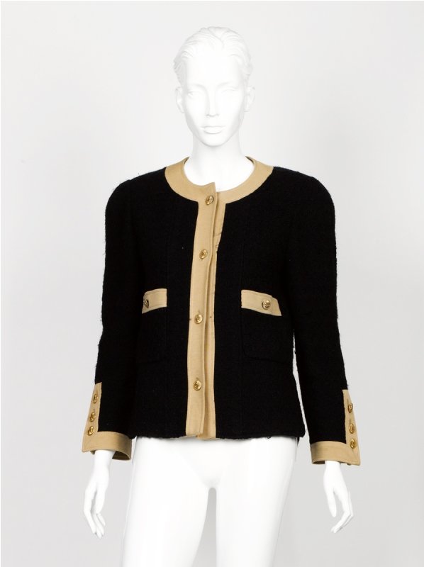 Chanel Black Bouclé Jacket: Chanel Black Bouclé Jacket of collarless design, with tan trim, four 'CC' logo button closure down front, two pouch pockets with button closure, decorative 'CC' buttons on each cuff, fully line